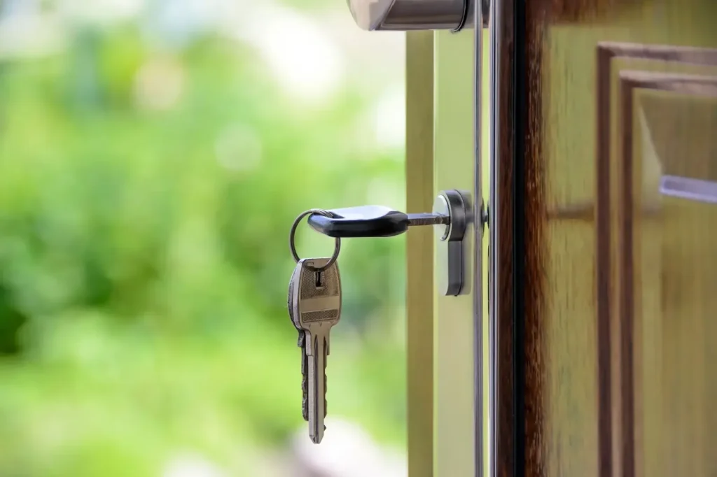 How to choose a trustworthy locksmith in Birmingham – key in the lock of an open front door, Locksmith Birmingham guide to avoiding common locksmith scams